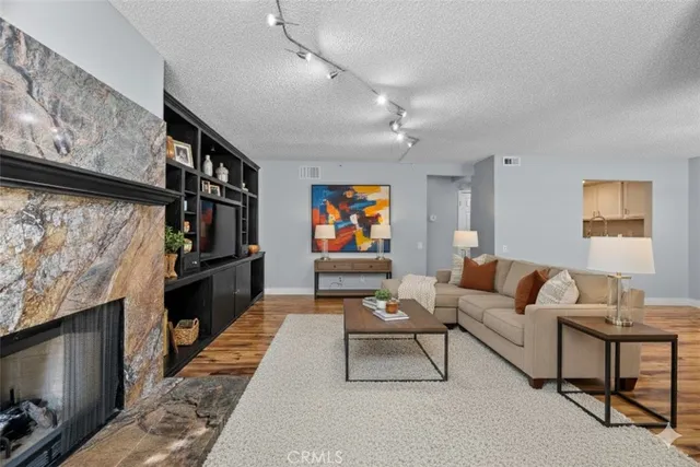 a living room with furniture a flat screen tv and a fireplace
