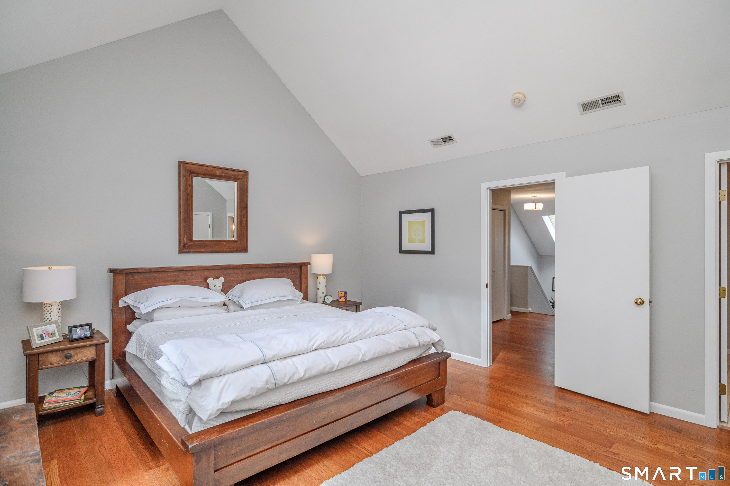 6 Echowoods Circle, Unit 6 Monroe, CT 06468 - Photo 16 of 25 a bedroom with a bed and wooden floor