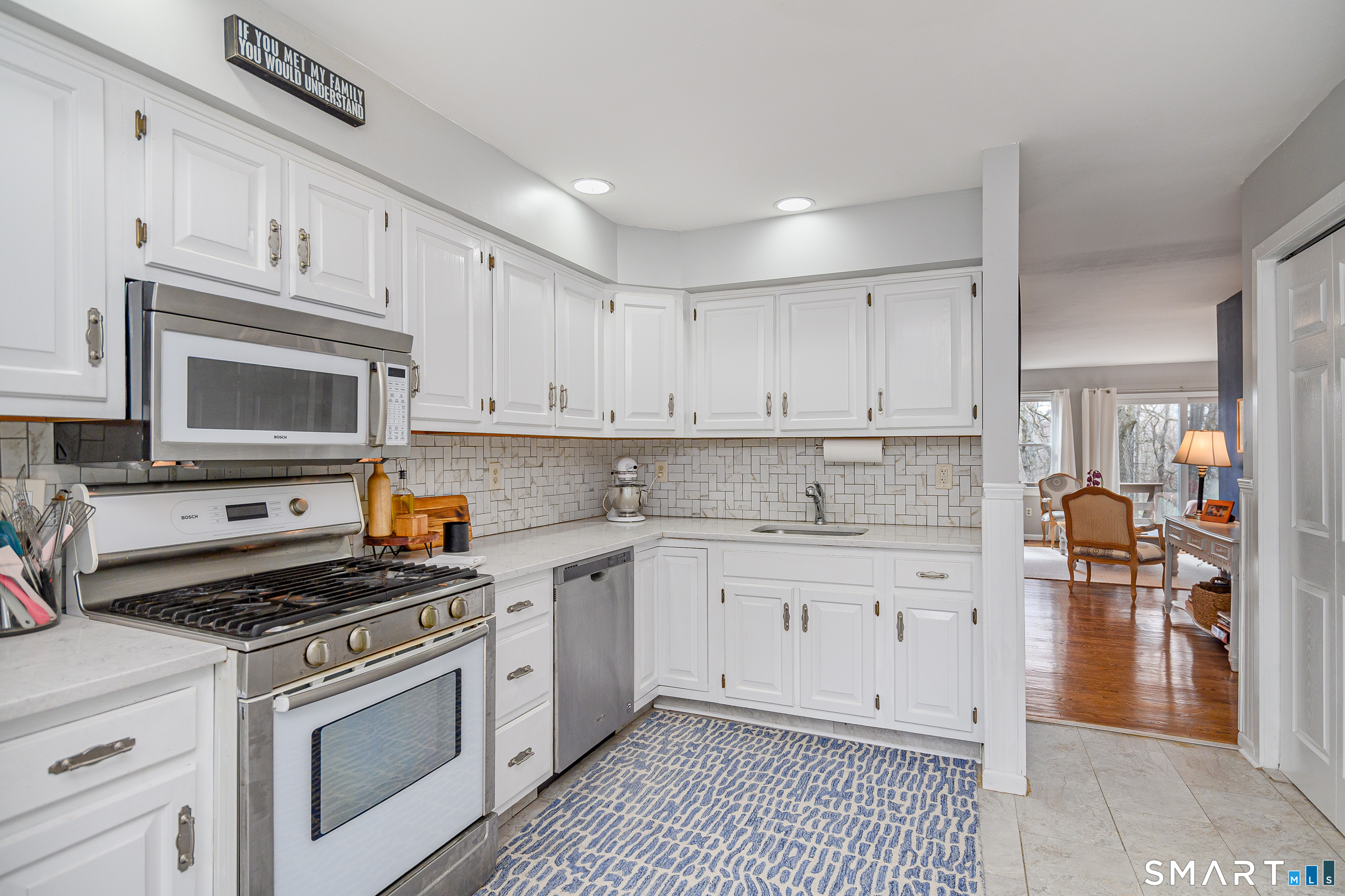 6 Echowoods Circle, Unit 6 Monroe, CT 06468 - Photo 4 of 25 a kitchen with granite countertop a stove a sink and a microwave