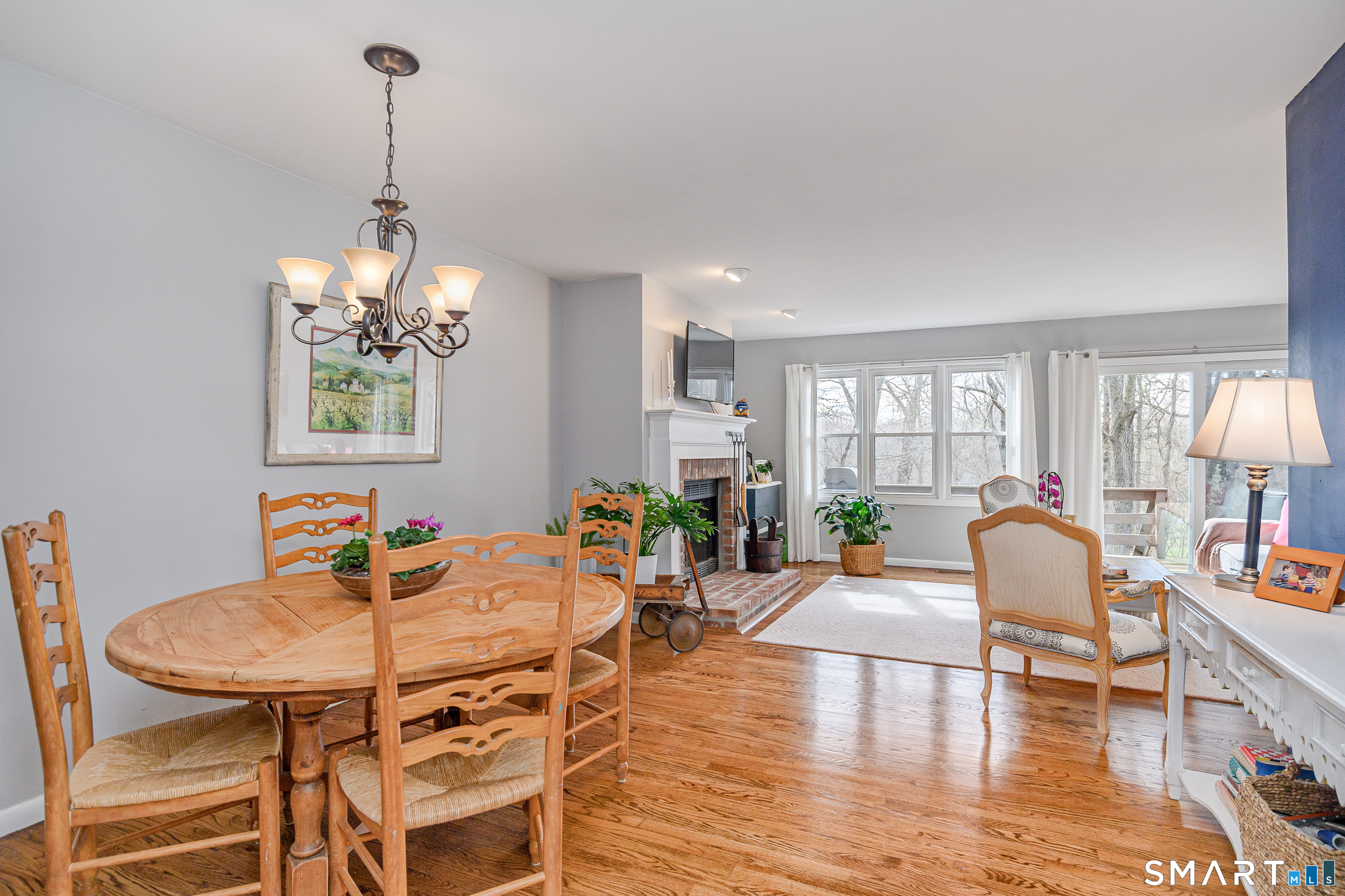 6 Echowoods Circle, Unit 6 Monroe, CT 06468 - Photo 6 of 25 a dining room with furniture a chandelier and wooden floor