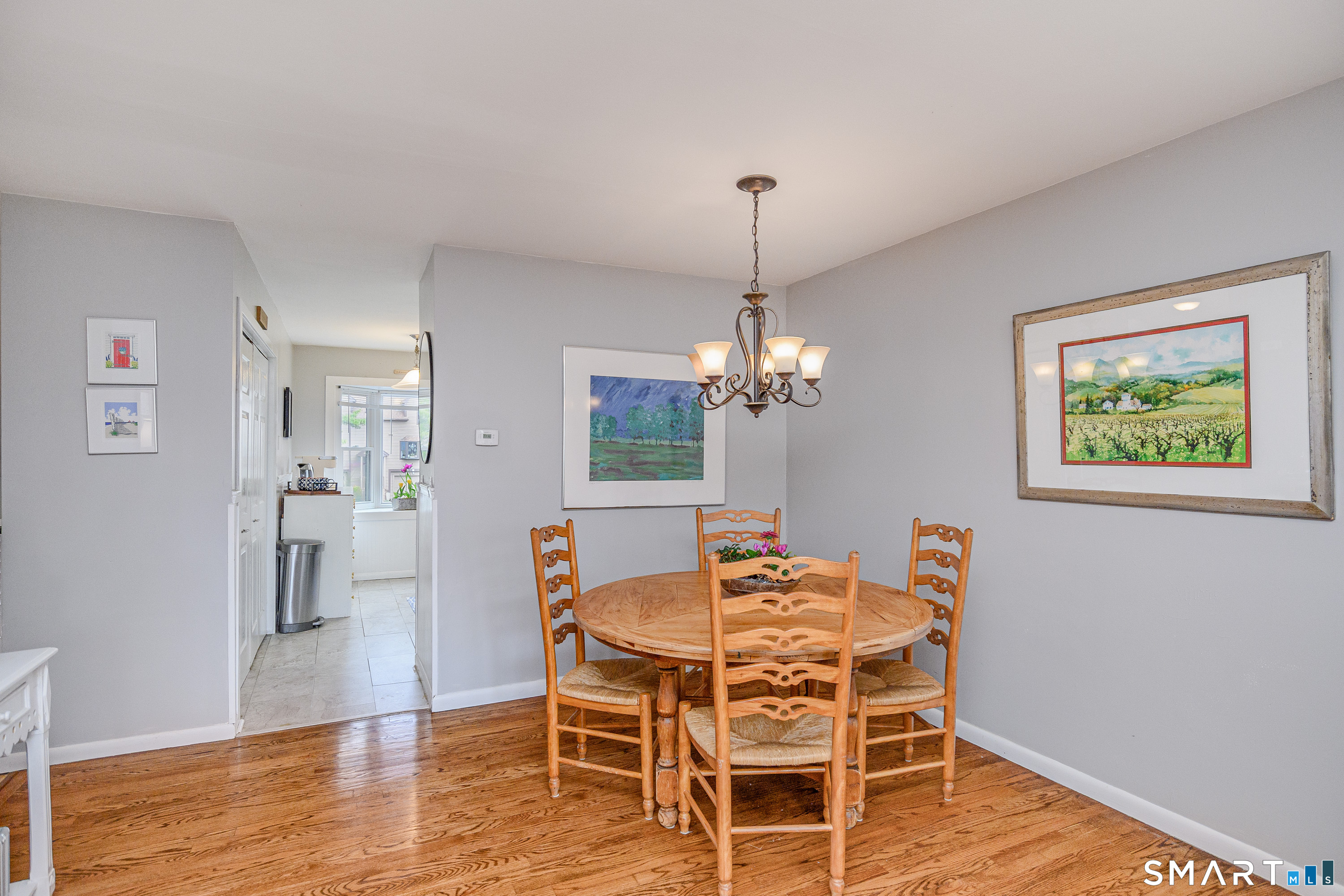 6 Echowoods Circle, Unit 6 Monroe, CT 06468 - Photo 7 of 25 a view of a dining room with furniture wooden floor and chandelier