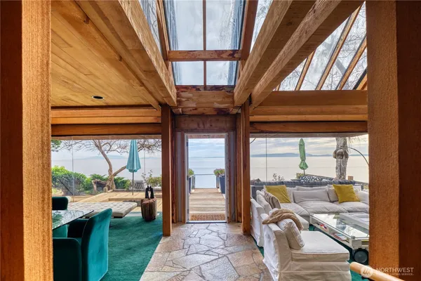 a view of a porch with furniture and floor to ceiling window