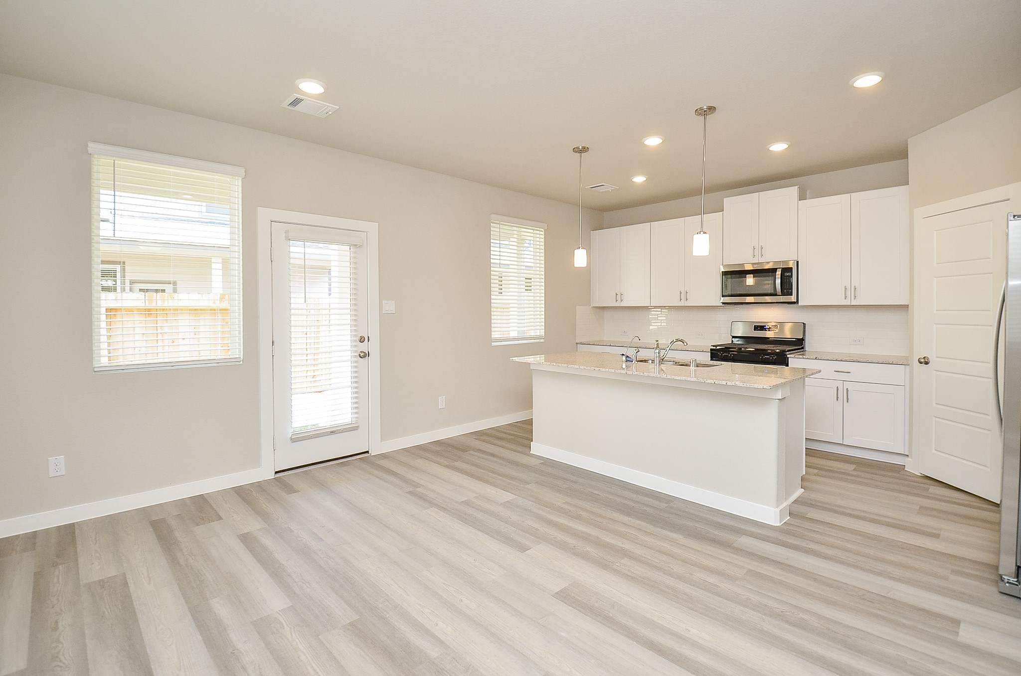 3107 Boulder Rnch Drive Houston, TX 77063 - Photo 14 of 40 a kitchen with granite countertop white cabinets and white appliances