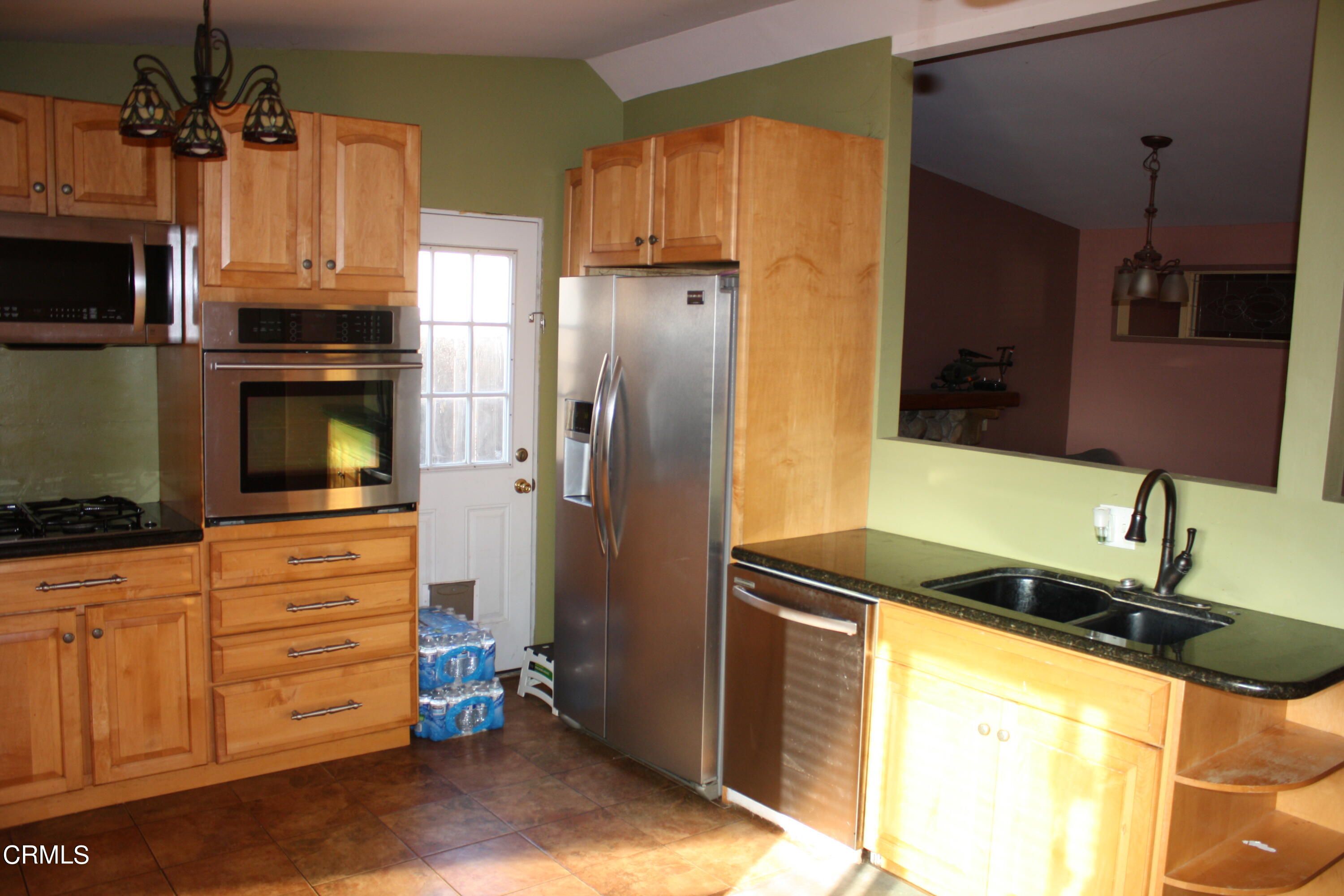 3500 Madera Place Oxnard, CA 93033 - Photo 3 of 9 a kitchen with granite countertop a refrigerator and a stove top oven