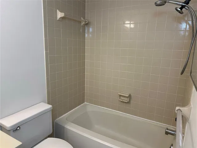 a white bath tub sitting next to a toilet