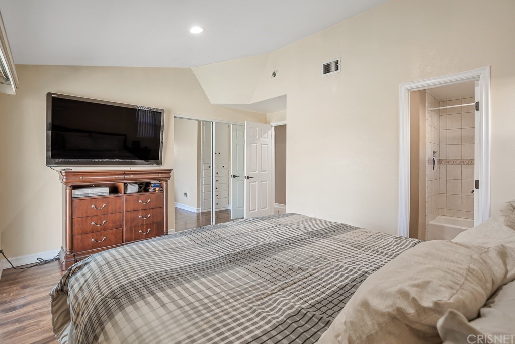 20610 Gresham Street Winnetka, CA 91306 - Photo 14 of 33 a bedroom with a bed and a flat screen tv