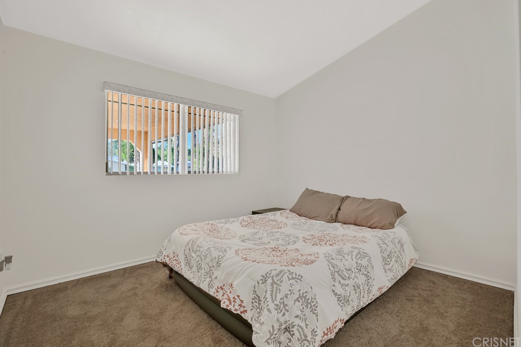 20610 Gresham Street Winnetka, CA 91306 - Photo 16 of 33 a bedroom with a bed and a window
