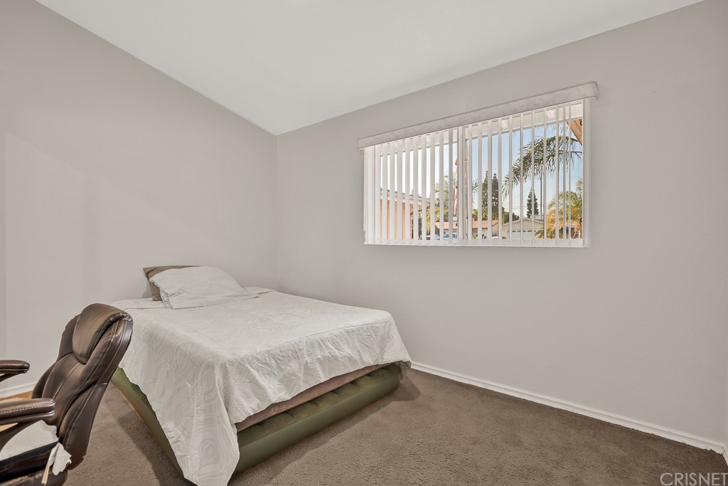 20610 Gresham Street Winnetka, CA 91306 - Photo 17 of 33 a bedroom with a bed and a window