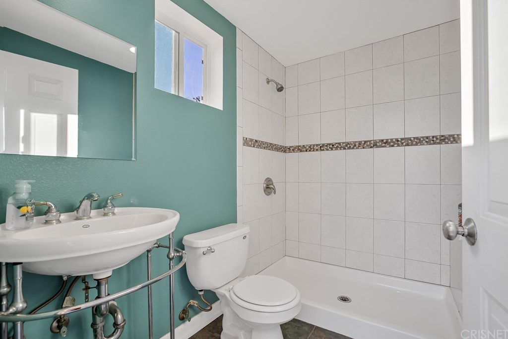 20610 Gresham Street Winnetka, CA 91306 - Photo 21 of 33 a bathroom with a sink a toilet and shower