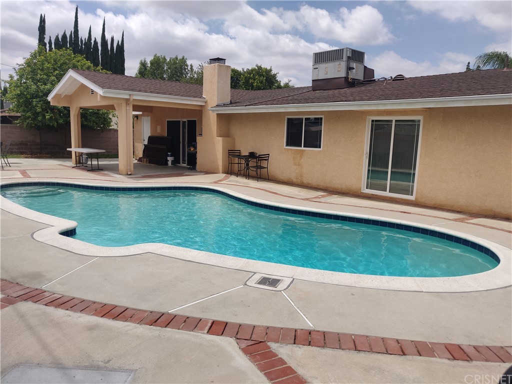 20610 Gresham Street Winnetka, CA 91306 - Photo 23 of 33 a view of a house with a swimming pool and a chairs