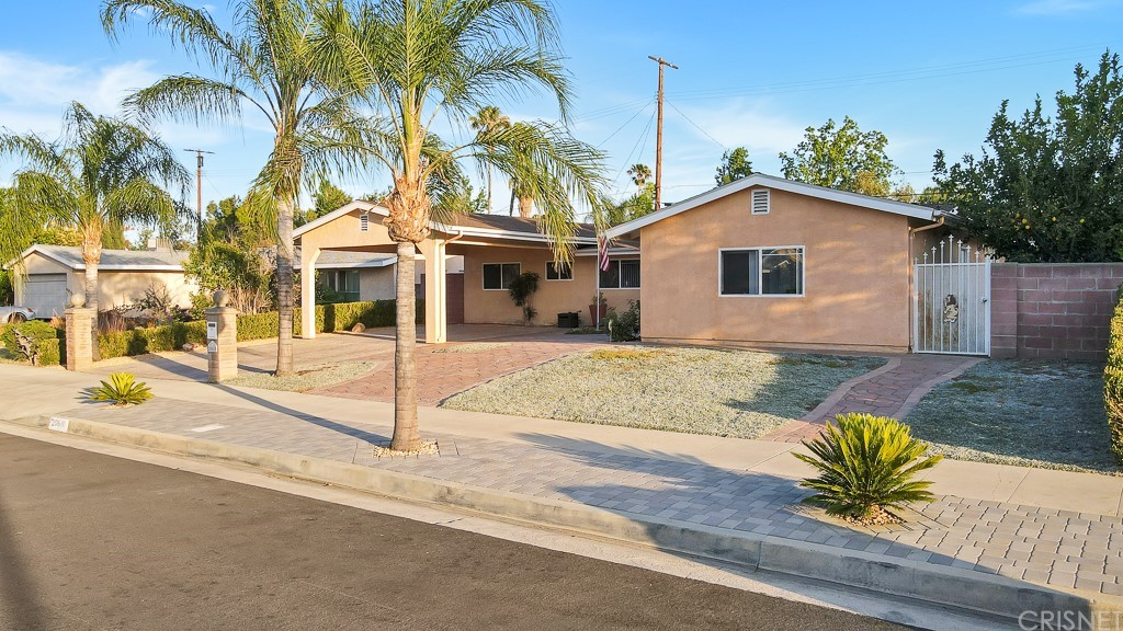 20610 Gresham Street Winnetka, CA 91306 - Photo 30 of 33 a front view of a house with a yard