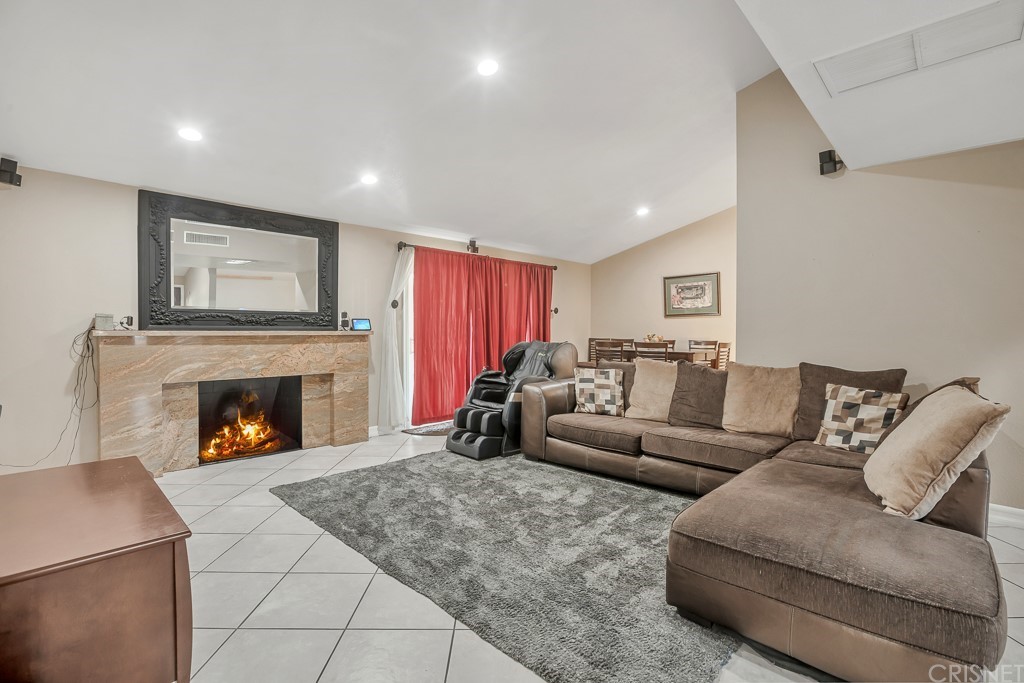 20610 Gresham Street Winnetka, CA 91306 - Photo 5 of 33 a living room with furniture and a fireplace
