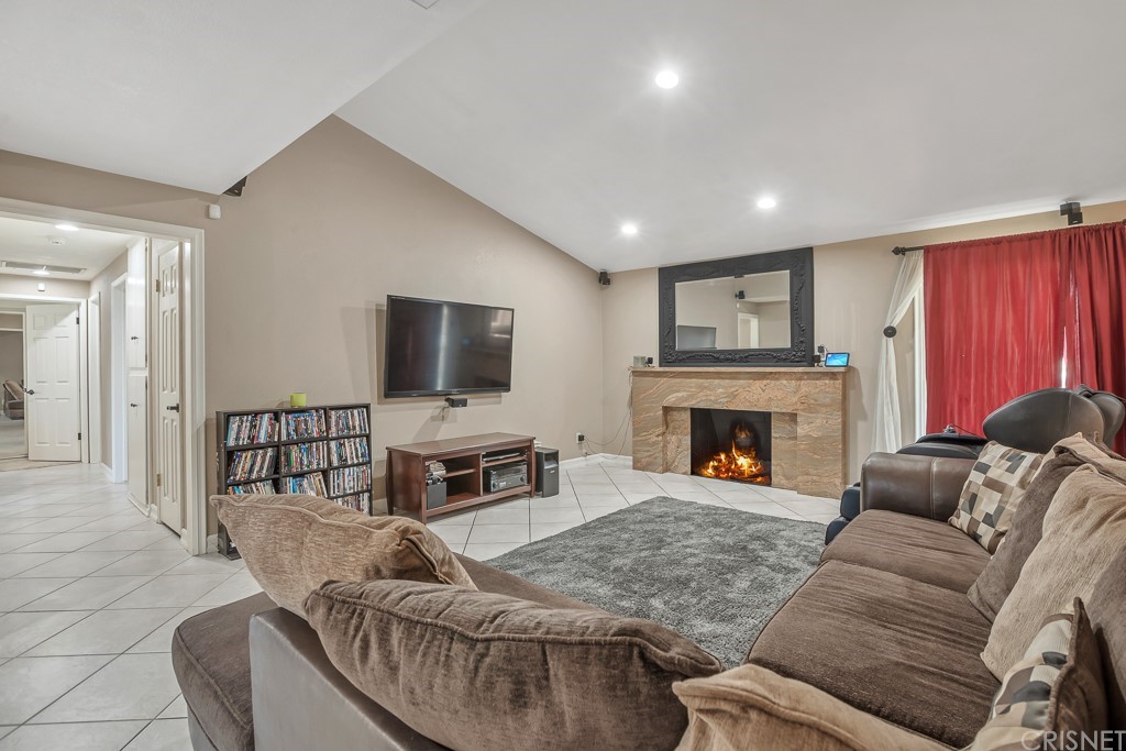 20610 Gresham Street Winnetka, CA 91306 - Photo 6 of 33 a living room with furniture and a fireplace