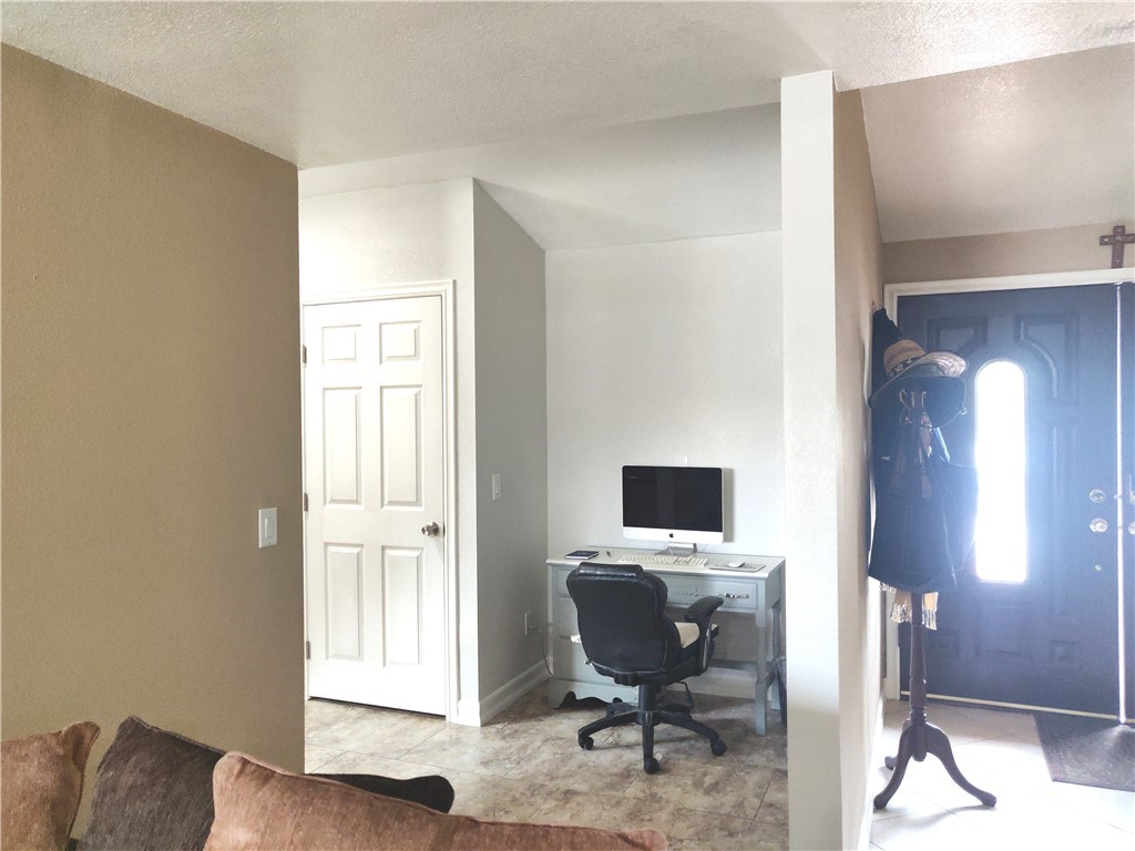 20610 Gresham Street Winnetka, CA 91306 - Photo 9 of 33 a view of a workspace with furniture and a window