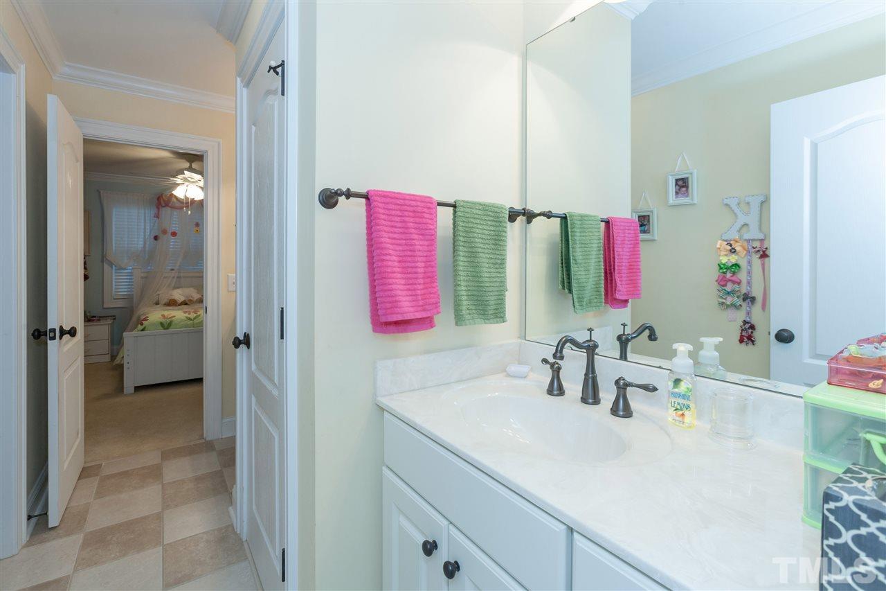 4300 Oakthorne Way Raleigh, NC 27613 - Photo 14 of 25 a bathroom with a sink vanity and a mirror