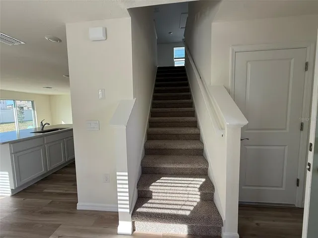 a view of entryway and hall with wooden floor