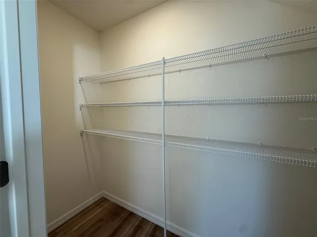 a view of a room with wooden floor