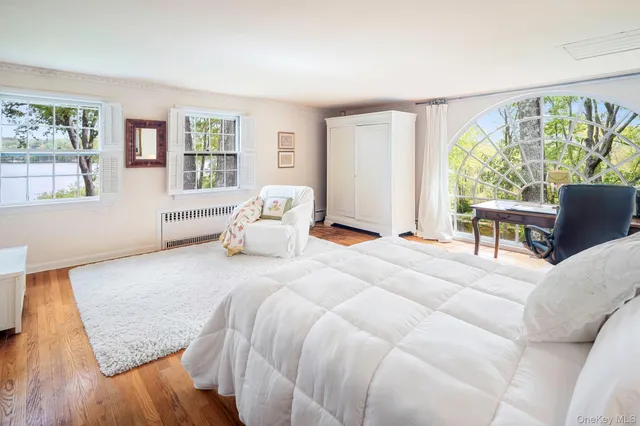 a bedroom with a large bed and a window