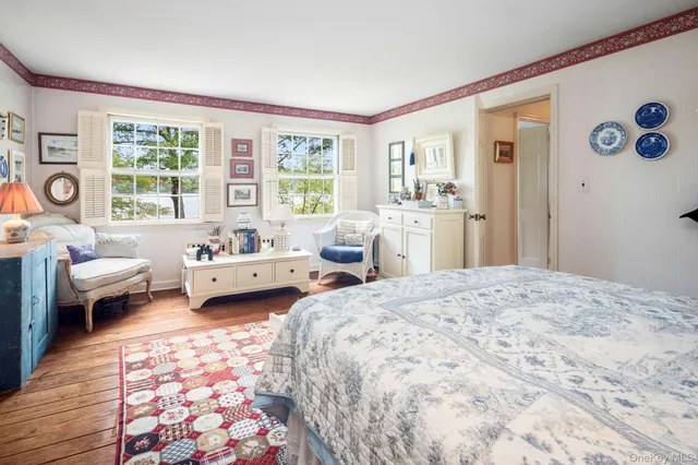 a bedroom with a bed couch and a window