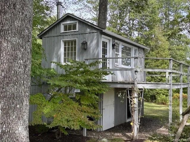 a view of wooden house with a large window
