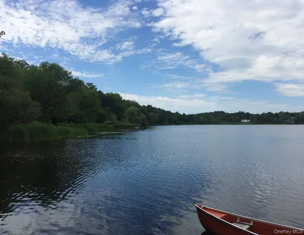 a view of water covered with snow in the background