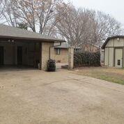 2109 Meadow Lane Grand Prairie, TX 75050 - Photo 17 of 17 a front view of a house with a yard