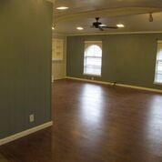 2109 Meadow Lane Grand Prairie, TX 75050 - Photo 4 of 17 an empty room with wooden floor and windows