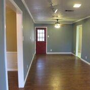 2109 Meadow Lane Grand Prairie, TX 75050 - Photo 5 of 17 an empty room with wooden floor and windows