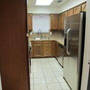 2109 Meadow Lane Grand Prairie, TX 75050 - Photo 6 of 17 a bathroom with a granite countertop sink a mirror and shower