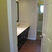 2109 Meadow Lane Grand Prairie, TX 75050 - Photo 8 of 17 a bathroom with a sink and a mirror