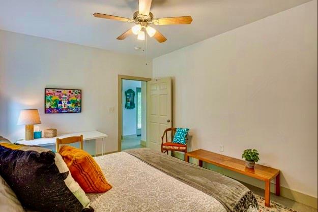 14217 Alamo Road Log Cabin, TX 75148 - Photo 7 of 10 a bedroom with a bed and a chandelier