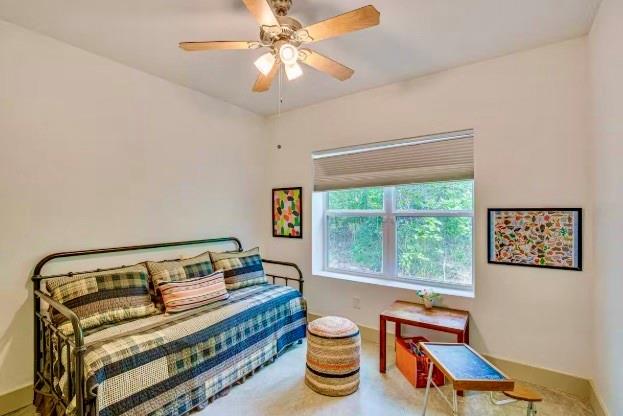 14217 Alamo Road Log Cabin, TX 75148 - Photo 8 of 10 a bedroom with a bed and a chandelier