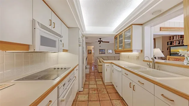 a kitchen with granite countertop a sink and cabinets