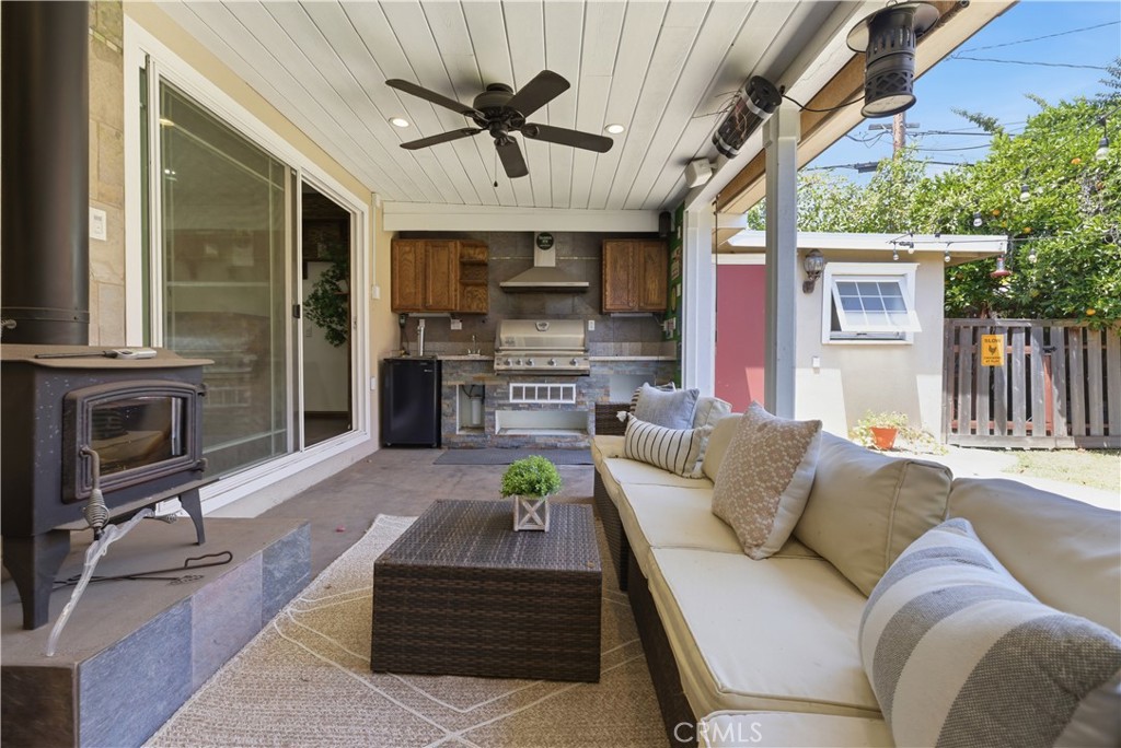 3327 North Studebaker Road Long Beach, CA 90808 - Photo 24 of 31 Entertaining covered patio with an outdoor kitchen, fireplace, and sliders from both the family room and the living room