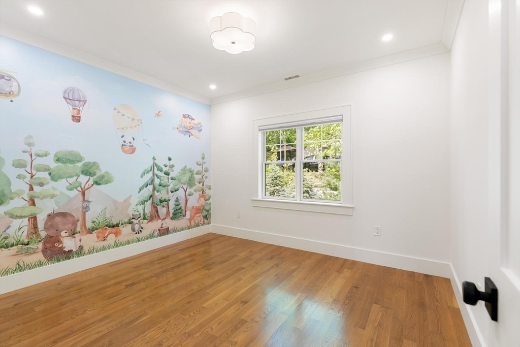 1124 Chestnut Street Newton, MA 02464 - Photo 22 of 41 an empty room with wooden floor and window