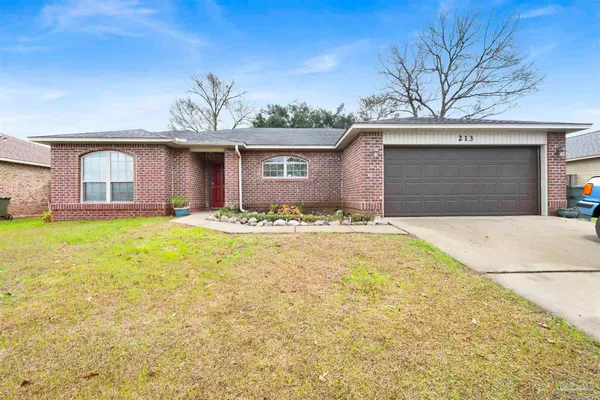 a view of a house with a yard and garage