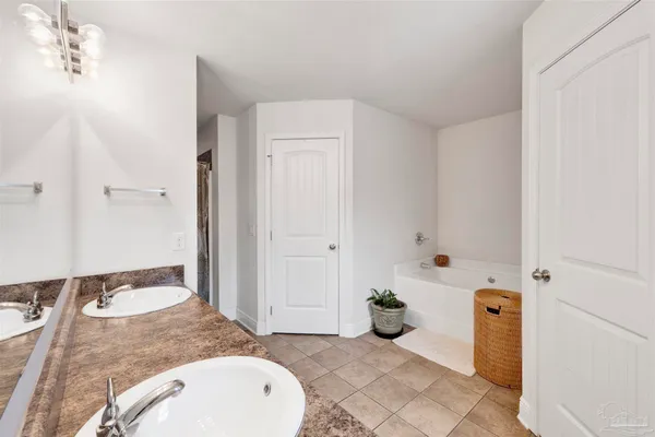 a spacious bathroom with a granite countertop sink and a mirror