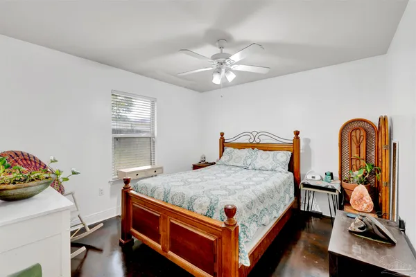 a bedroom with bed and windows