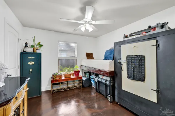 a bedroom with furniture and a window