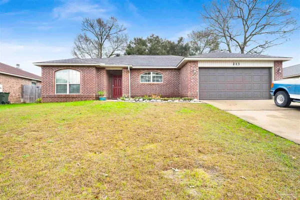 a view of a house with a yard and garage