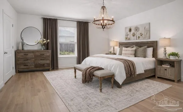 a bedroom with a bed a dresser and chair