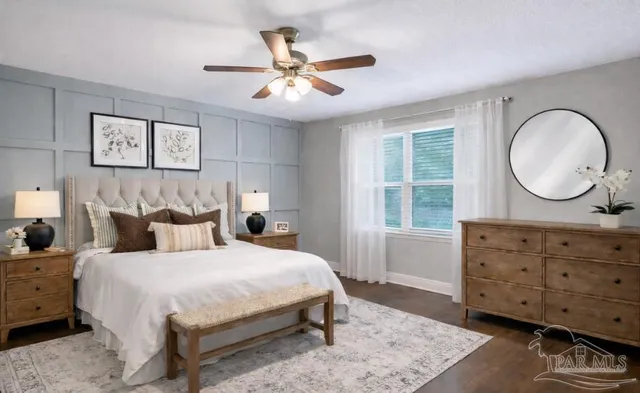 a bedroom with a bed a dresser and chair