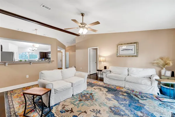 a living room with furniture and a large mirror
