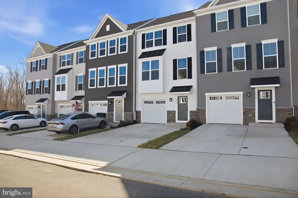 a view of a street that has couple of cars parked in front of it