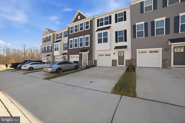 a couple of cars parked in front of a building