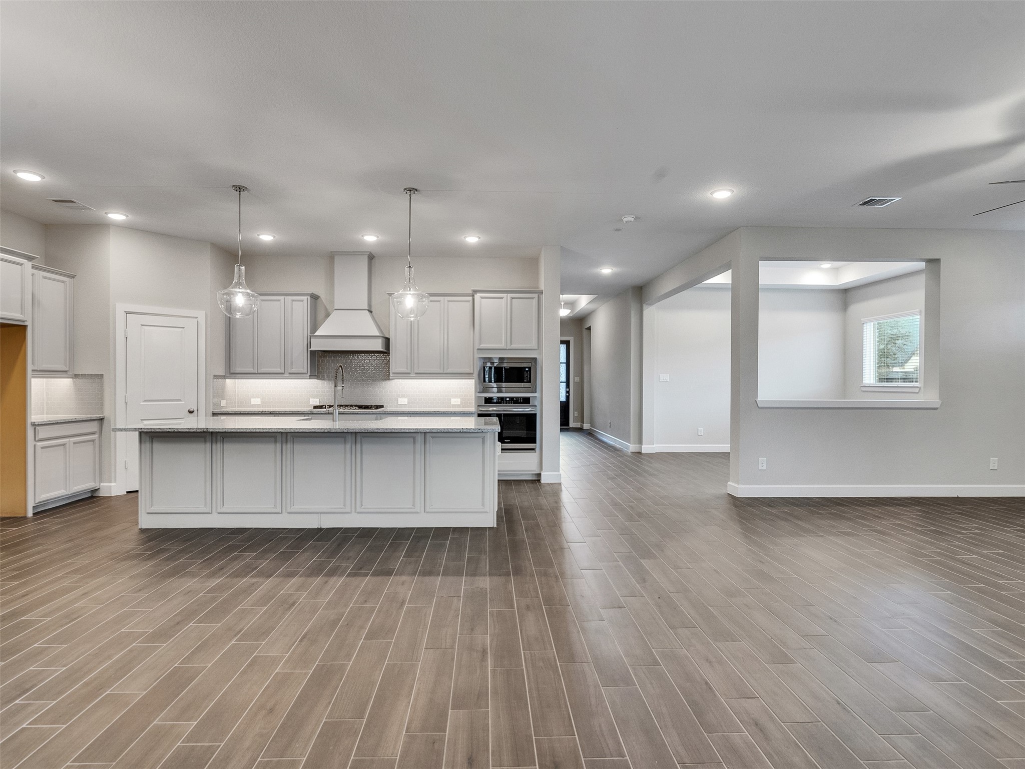 7003 Goldstrum Way Katy, TX 77493 - Photo 14 of 44 a view of kitchen with kitchen island wooden floors appliances and cabinets