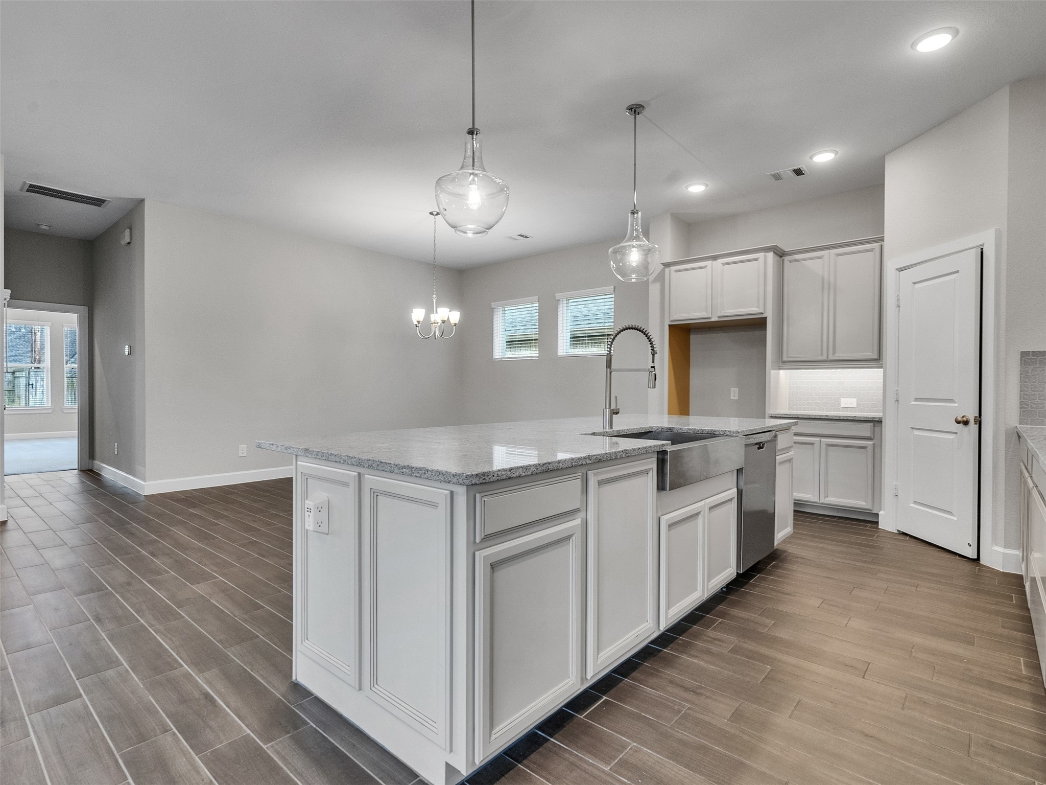7003 Goldstrum Way Katy, TX 77493 - Photo 15 of 44 a large kitchen with kitchen island a large counter space a sink appliances and cabinets