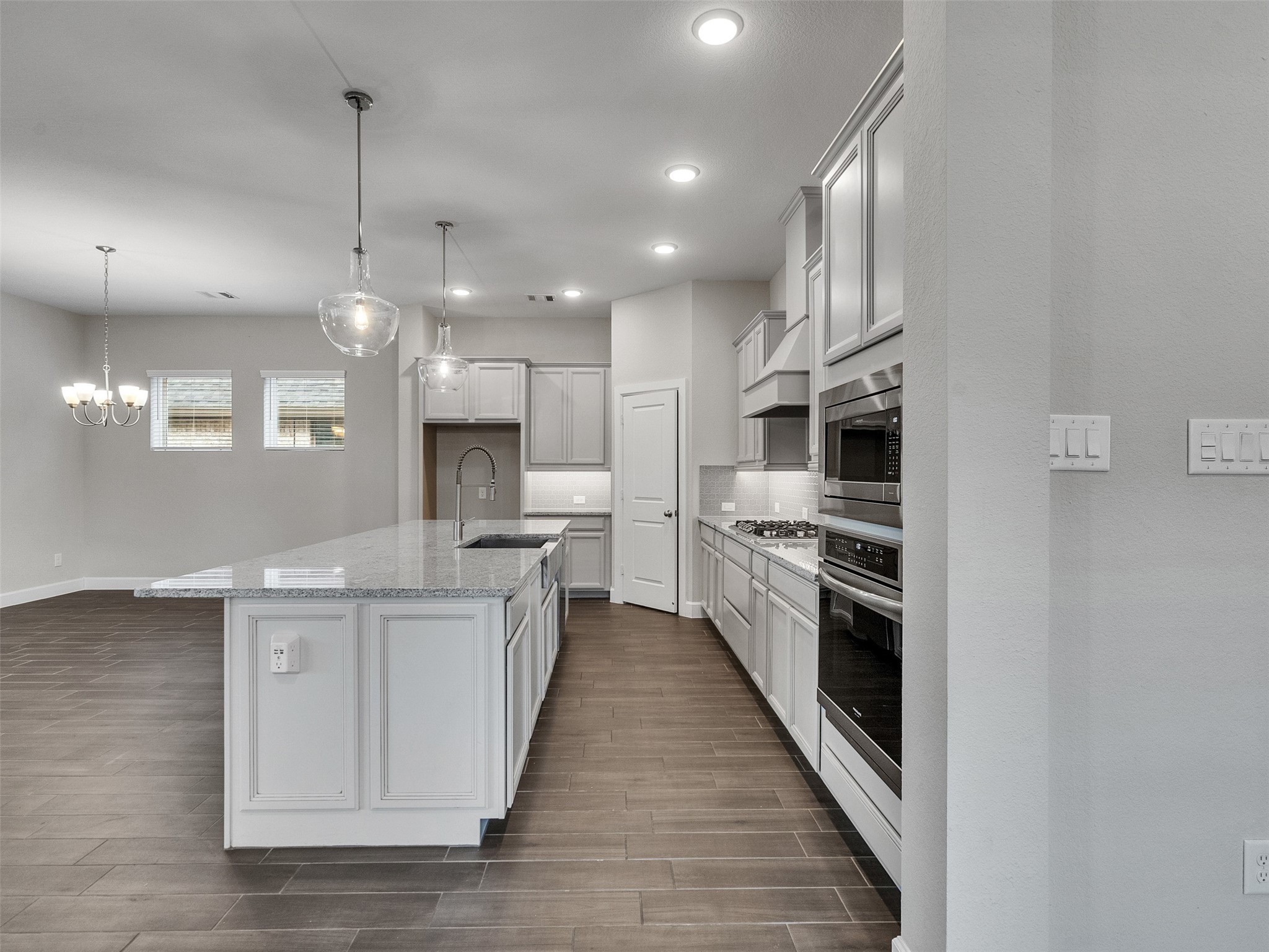 7003 Goldstrum Way Katy, TX 77493 - Photo 19 of 44 a large kitchen with white cabinets and stainless steel appliances