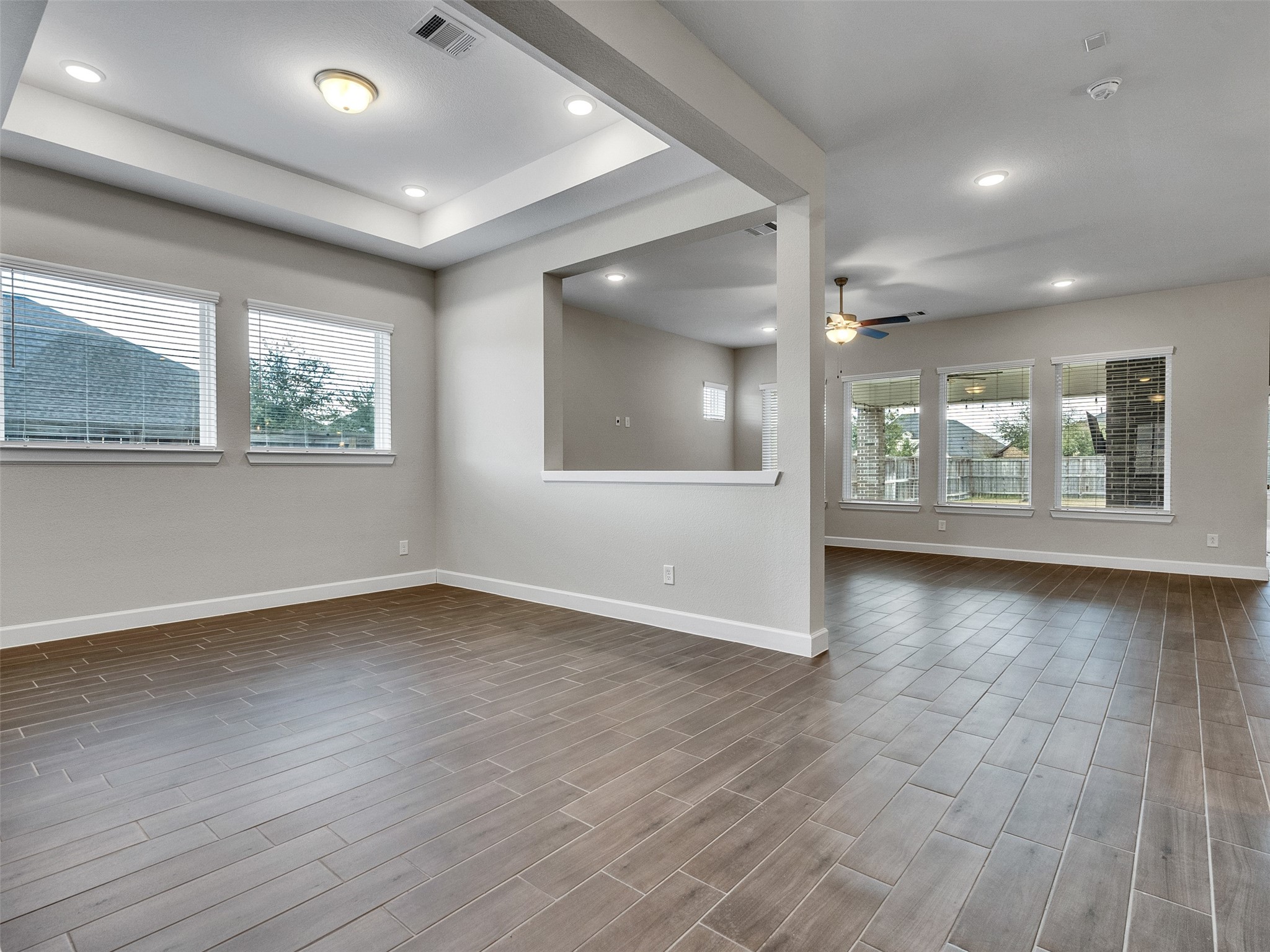 7003 Goldstrum Way Katy, TX 77493 - Photo 7 of 44 an empty room with wooden floor and windows