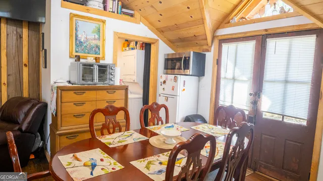 a dining room with furniture and window